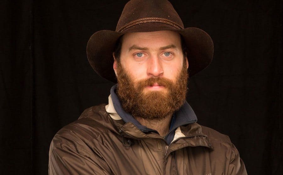 Portrait of Matt wearing a brown hat. 