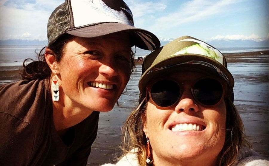 Misty takes a selfie with a fishing friend on a Hawaiian beach. 