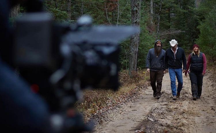 The Raney's are filmed as they walk through the forest. 