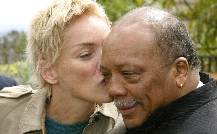 Sharon Stone kisses Quincy Jones, on the cheek. 