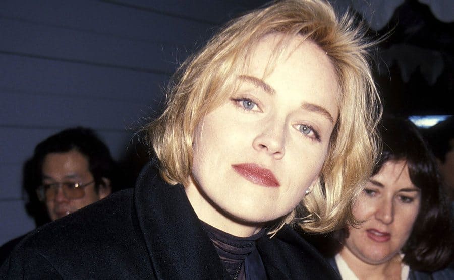 Paparazzi take a headshot of Sharon Stone as she attends an event.