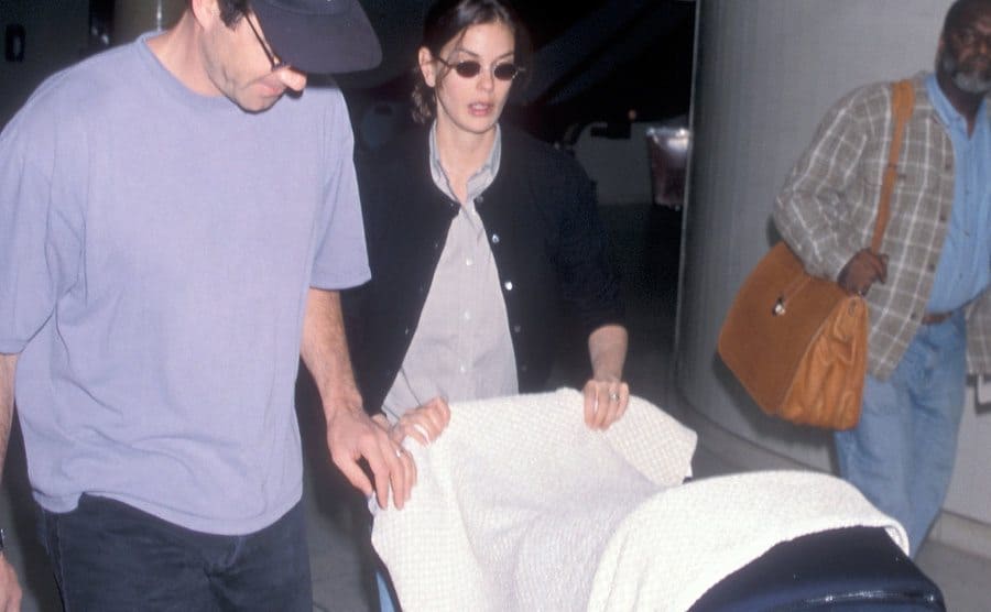 Teri Hatcher, Jon Tenney, and their baby daughter, Emerson Tenney, arrive at the airport circa 1998.