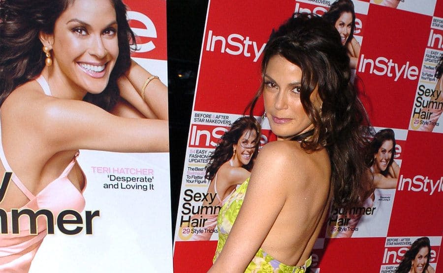 Teri Hatcher is posing next to InStyle Magazine posters covers of her.