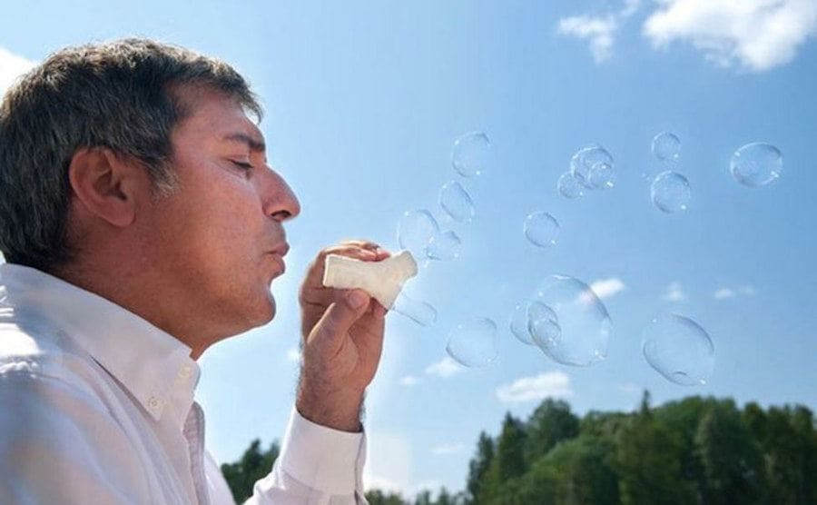 Paolo Macchiarini is blowing bubbles through the synthetic windpipe he created. 