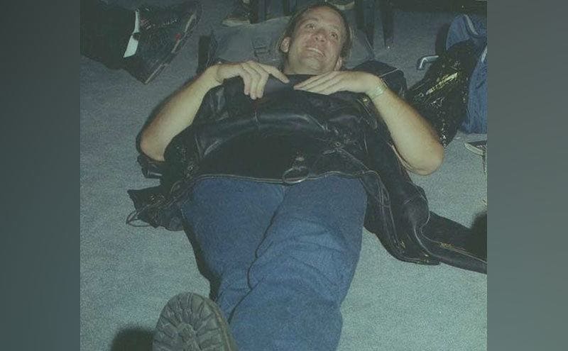 A young Jesse James is lying down in his garage. 