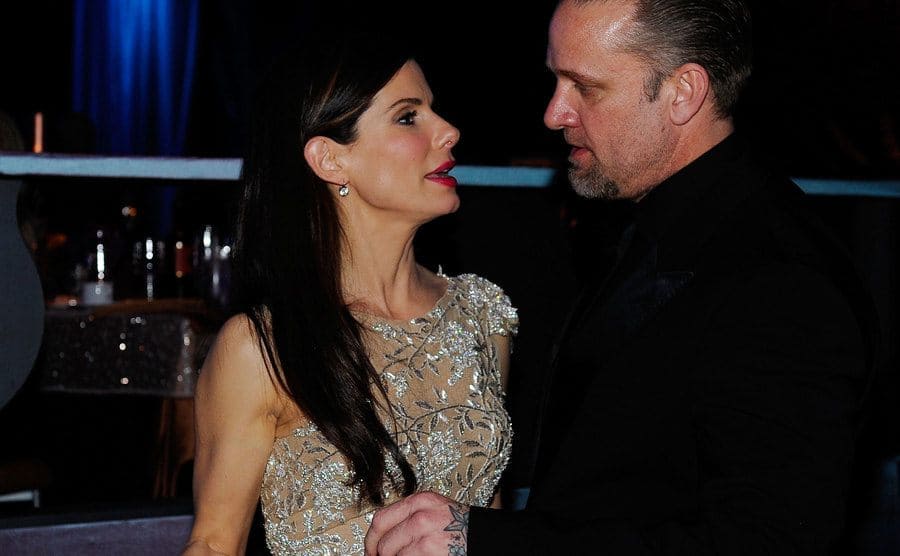 Sandra Bullock and Jesse James are having a conversation at the Academy Awards.