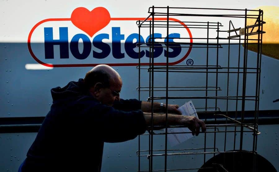 A Hostess driver for 16-years, pushes an empty rack alongside his truck. 