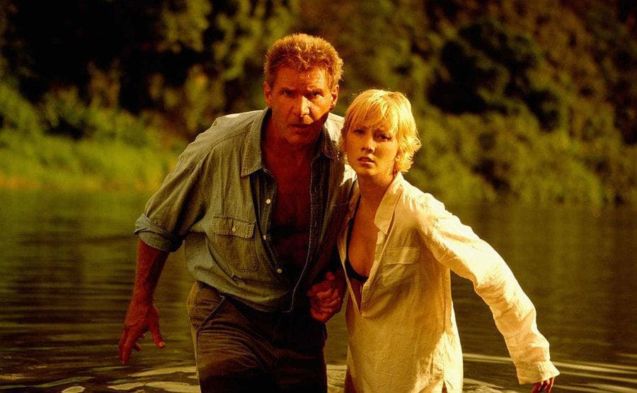 Harrison Ford and Anne Heche cross a river in a still from ‘Six Days, Seven Nights’. 