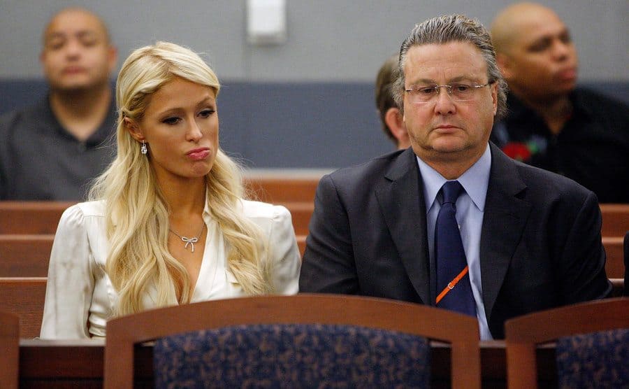 Paris Hilton and her attorney David Chesnoff sit in court. 