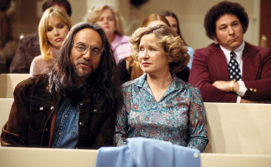 Leo and Kitty Forman are sitting in Church.