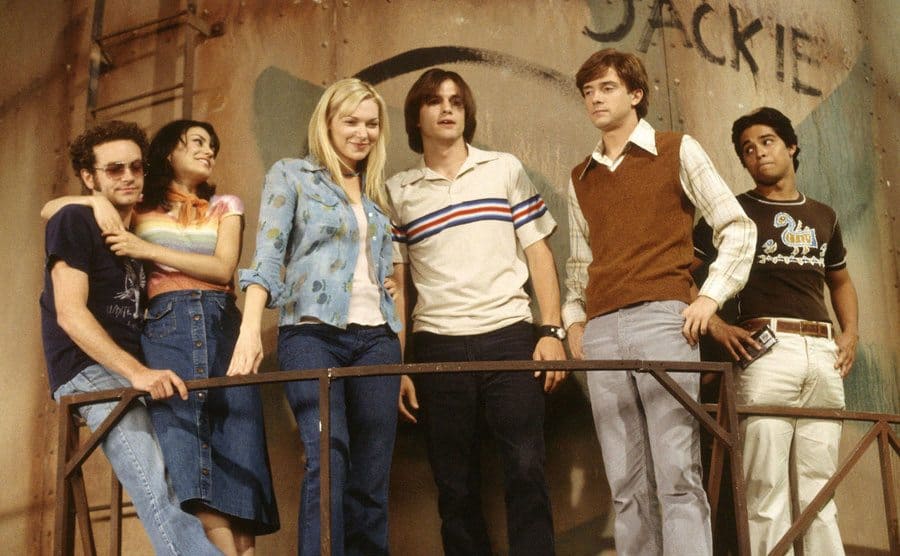 The teenage cast stands together in a scene from the finale. 