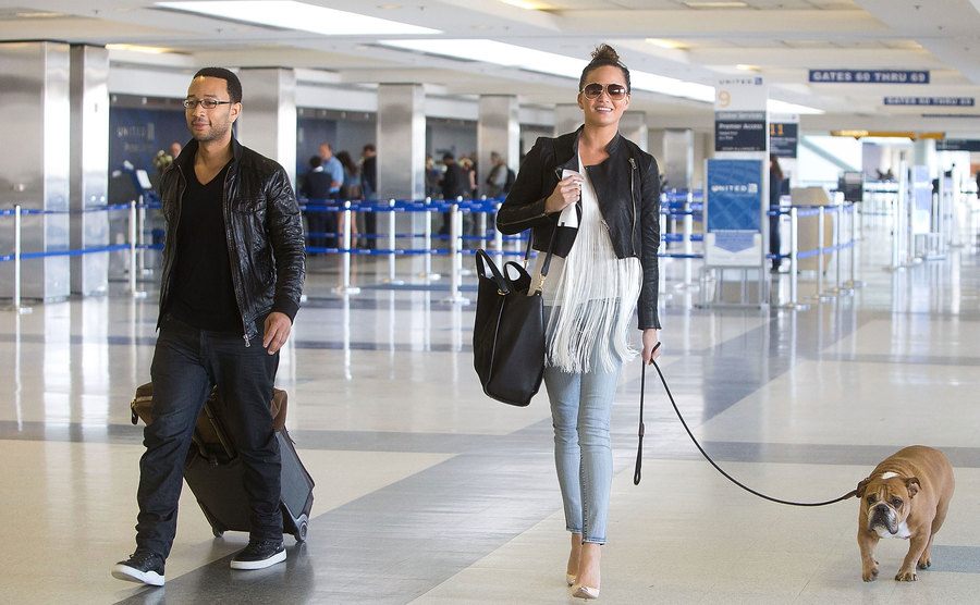 John Legend and Chrissy Teigen are seen at Los Angeles International Airport