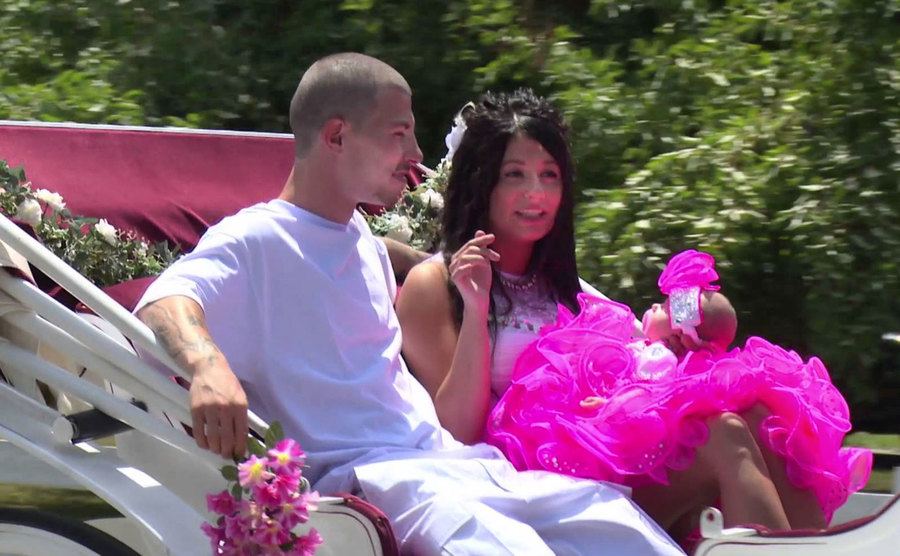 Newlyweds go for a ride in a carriage in a still from the show.