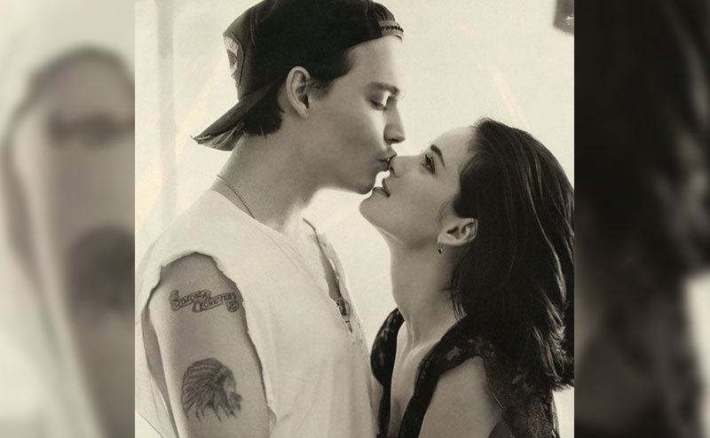 Depp embraces Winona as they pose for a portrait.
