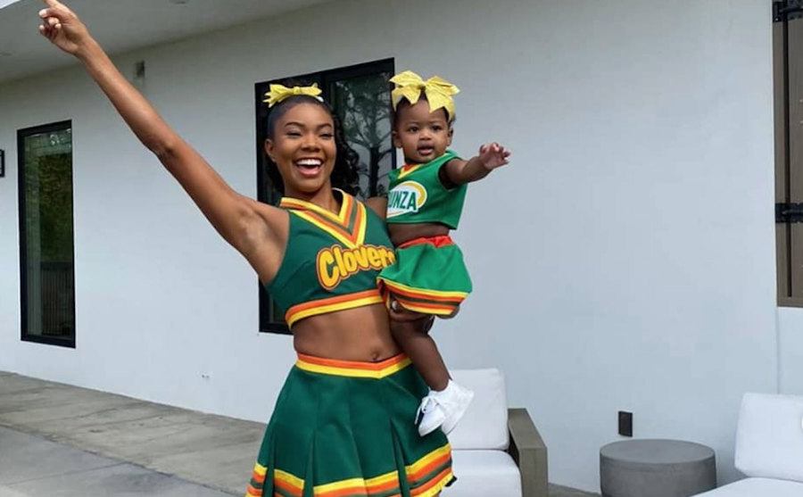 Gabriella Union wears her Clovers uniform with her baby girl in a matching outfit. 