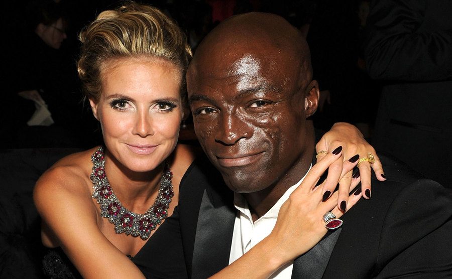 Heidi Klum wraps her arms around Seal during an event. 