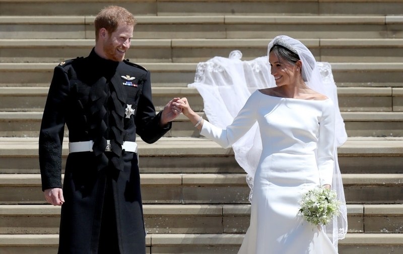 Prince Harry and Meghan Markle walk down the church steps. 