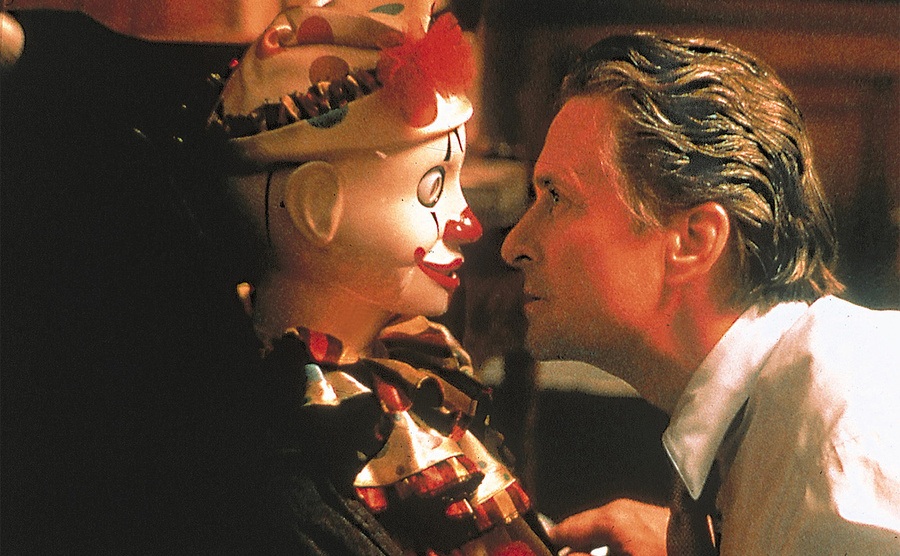 Michael Douglas stares at doll in a still from The Game. 