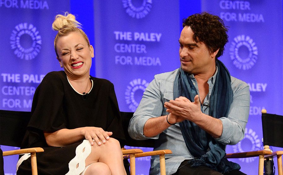 Kaley Cuoco and Johnny Galecki laugh during a press conference. 