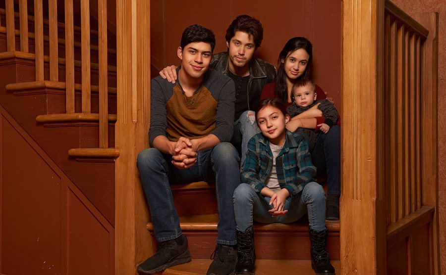 The Acosta siblings pose on their staircase at home. 