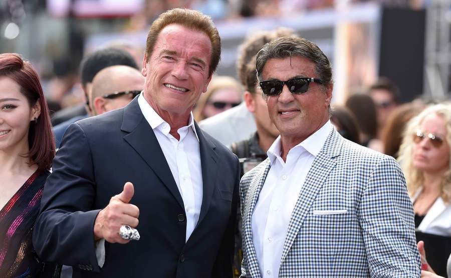 A photo of Schwarzenegger and Stallone during an event.