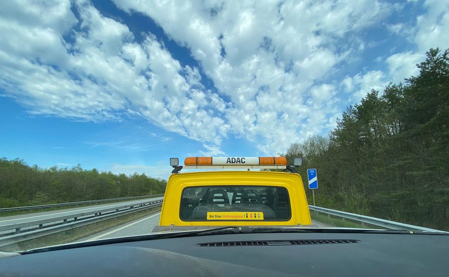 A photo of a tow truck on the road.