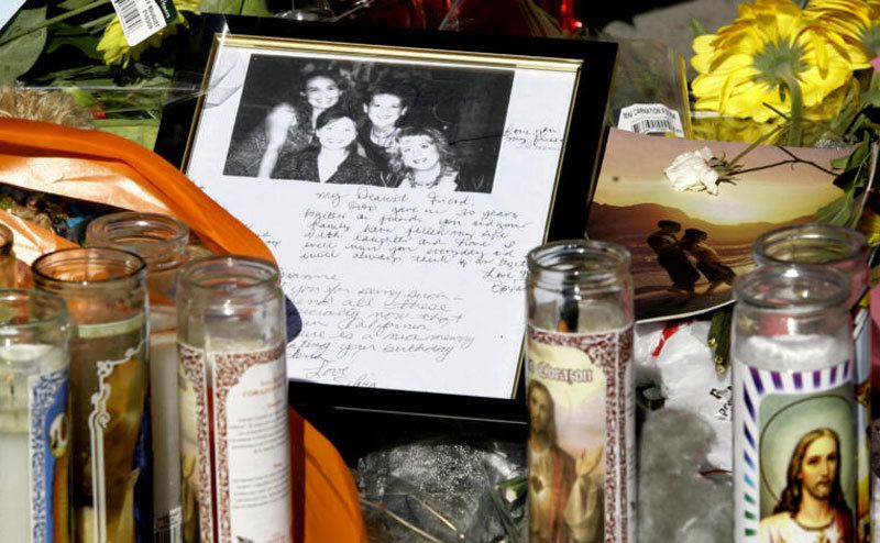 Photos, Notes, and candles are left outside the Ortega family home. 
