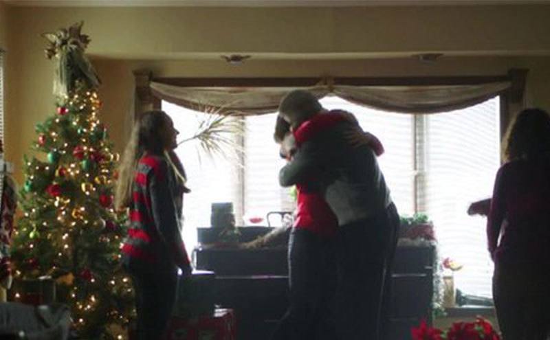 Family members embrace at home on Christmas. 