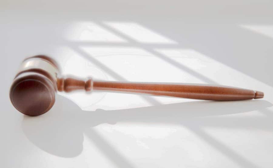 A picture of a gold-trimmed wooden judicial gavel.