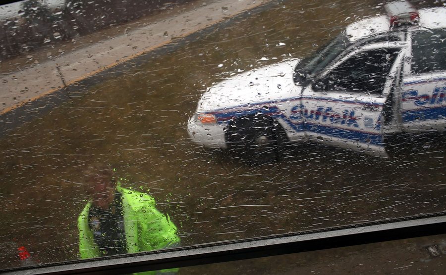 The police searches for remains by the road on a rainy day.