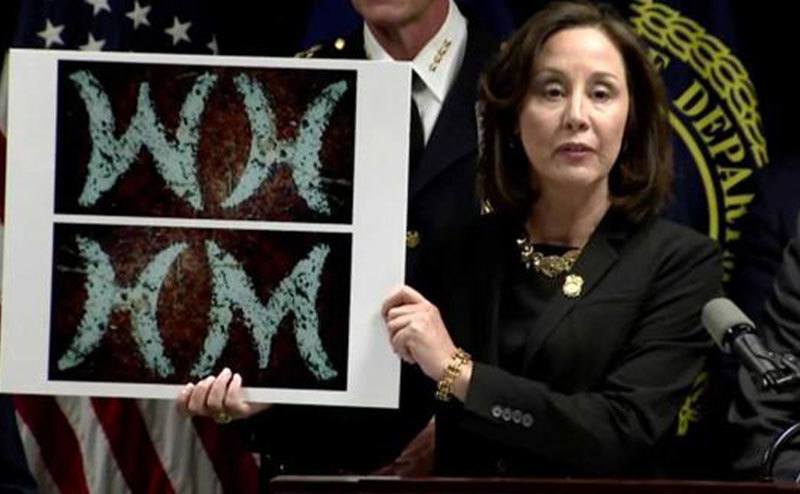 An FBI agent shows photos of the new evidence found to the media.