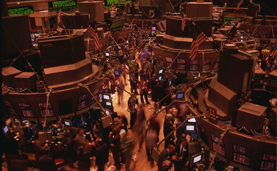 An image of New York stock exchange traders working on the trading floor.