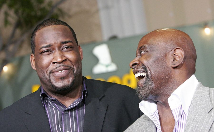 A portrait of Chris Jr. and Gardner laughing together.