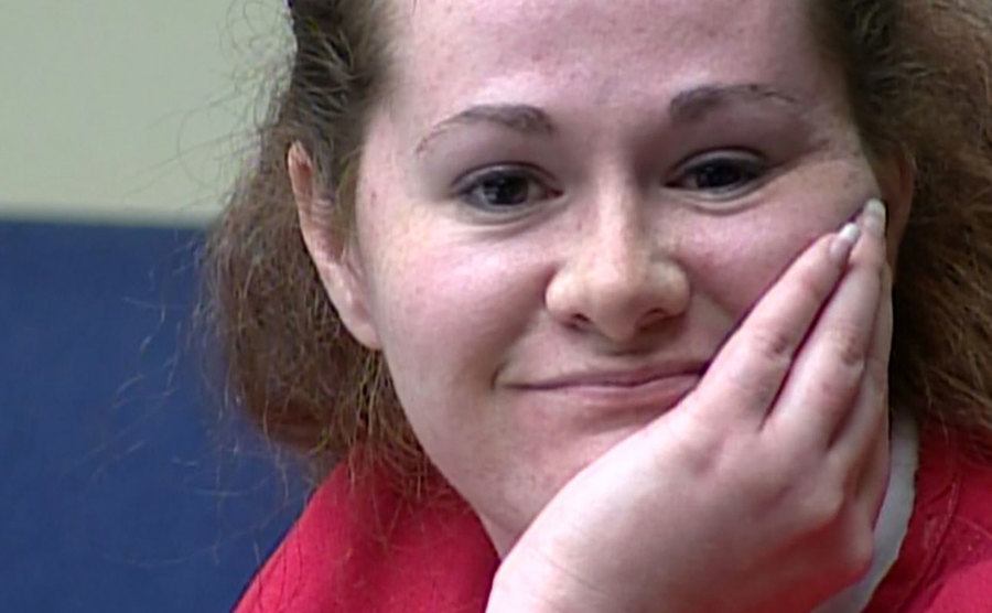 Christa smiles in court.