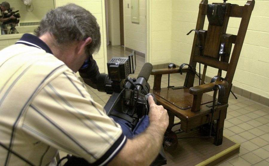 A news photographer collects video of the electric chair.