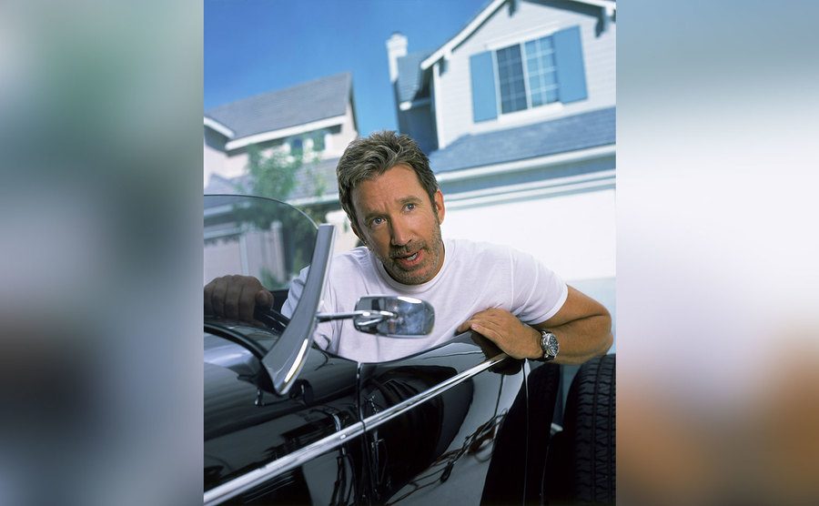 Tim Allen poses in a convertible. 