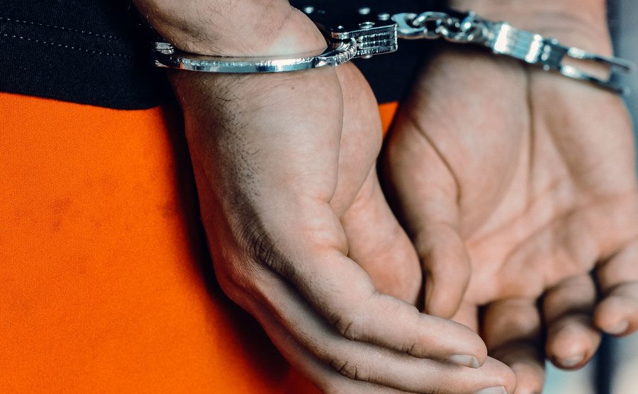 A picture of hands in cuffs.