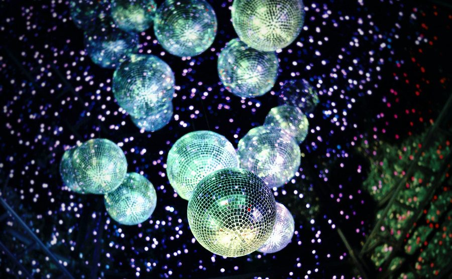An image of disco balls on a dance floor.