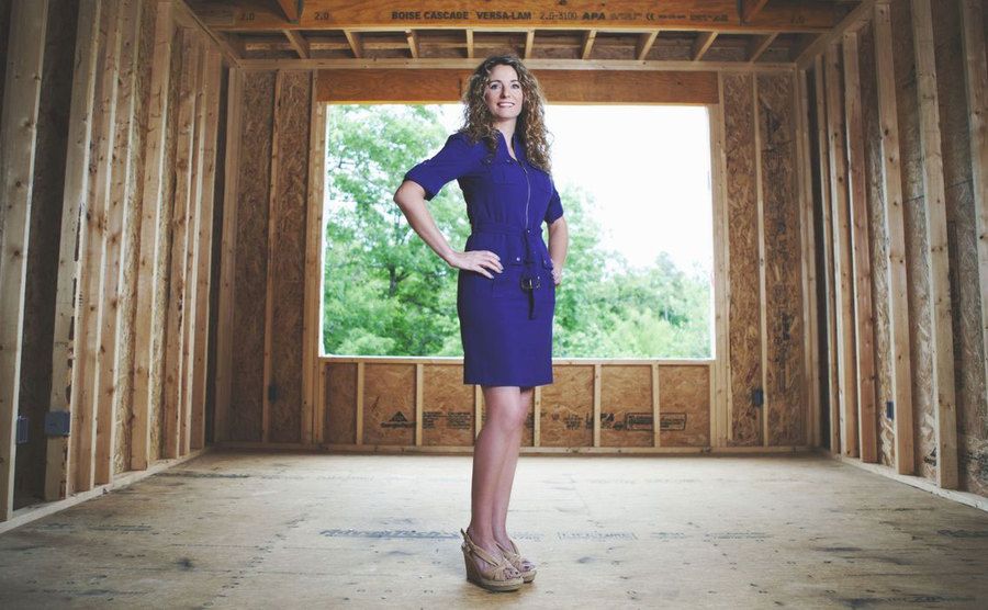 Cara Brookins poses inside her unfinished home. 