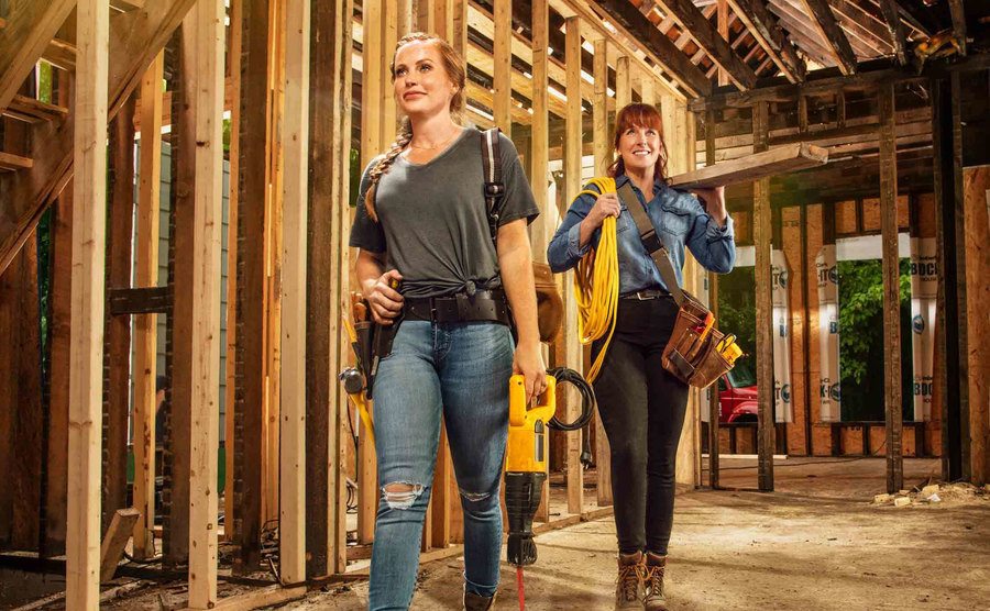 Mina and Karen walk into an unfinished home with their tools. 