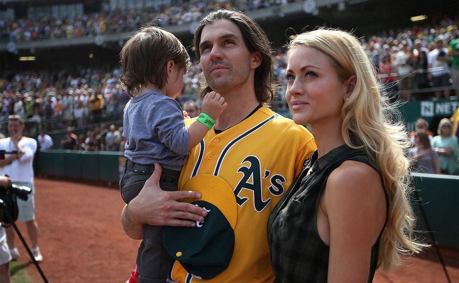 Barry Zito stands with Amber Zito and their son before the game