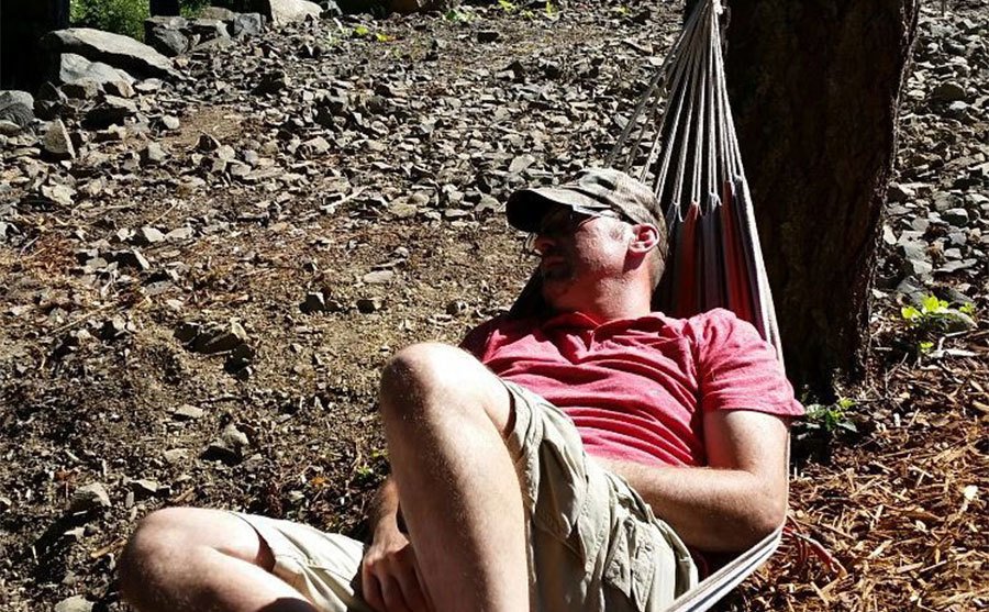 A photo of Dave lying on a hammock.