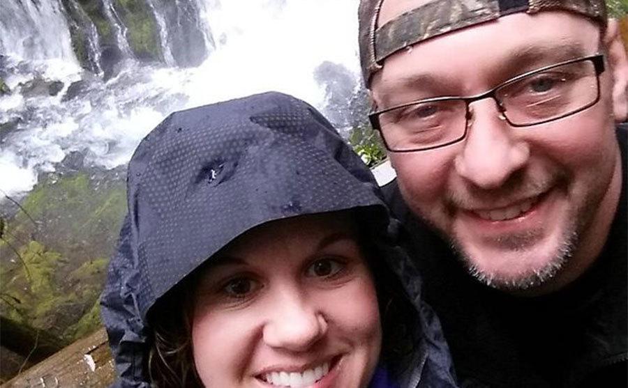 A picture of Jaimie and Dave next to a waterfall.