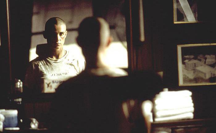 A still of Demi Moore staring in front of a mirror in a scene from the film.