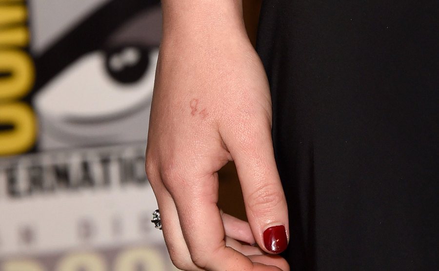 A close-up on the H2O hand tattoo. 
