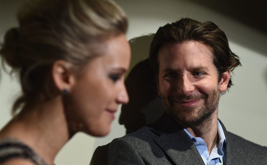 Bradly Cooper stares at Jennifer Lawrence during an event. 