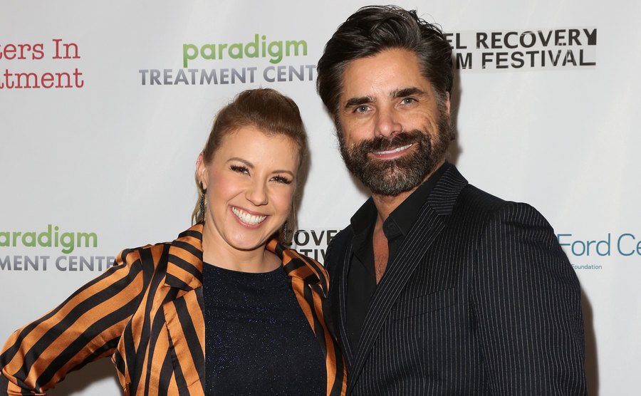 Jodie Sweetin and Stamos pose for the press.
