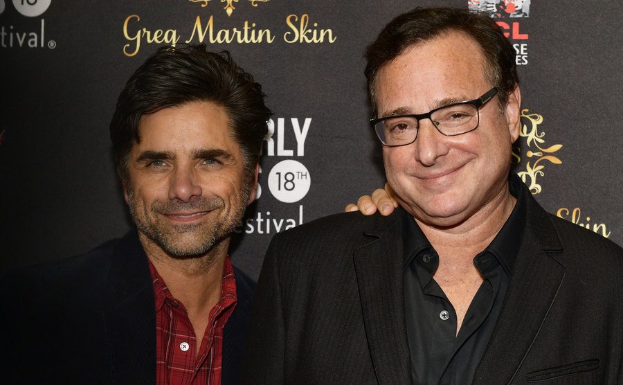A photo of Stamos and Saget posing for the press.
