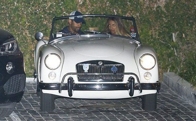 Russell Wilson and his date sit in his car. 