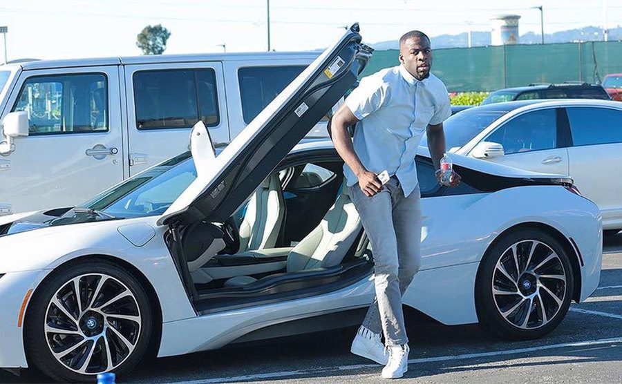 Draymond Green gets out of his BMW i8. 